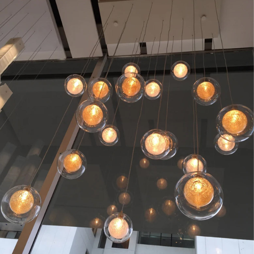 Foyer-two-story-chandelier-REFLECTION- Clear-glass-pendant-lighting, contemporary-modern-blown-glass-lighting, custom-long-staircase-lights.