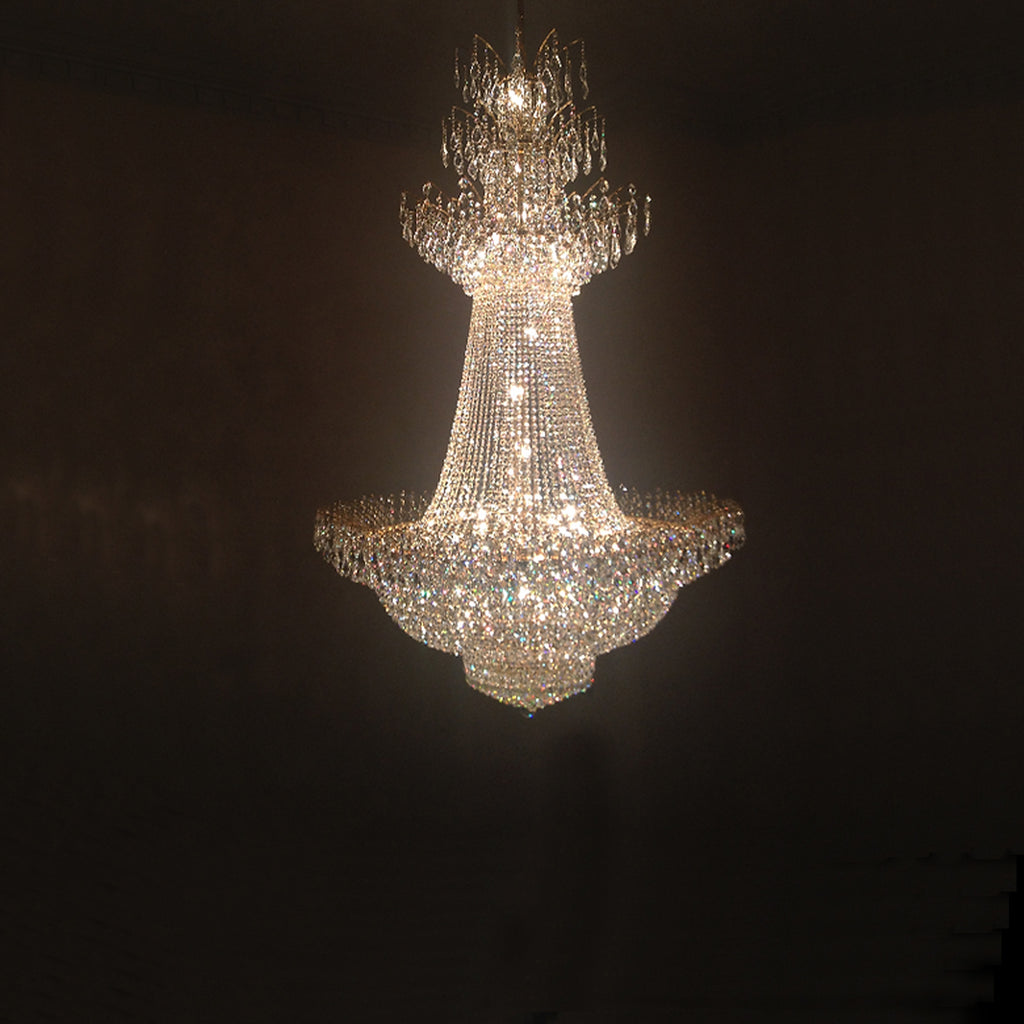 The Carla design features a three-tiered fountain-esque crystal construction which allows the light it emits to seem to flow throughout the room. The design and size of this chandelier make it excellent for large open areas, tall foyers, and any room where a significant amount of light is needed. This example features a white gold plated frame and dazzling Swarovski crystals.